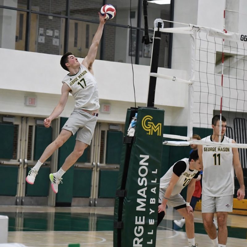 Derek spiking at the net for George Mason